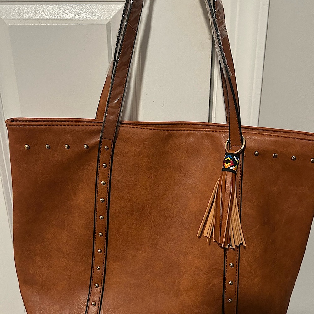 Unbranded women’s cognac color tote. New with plastic still on straps